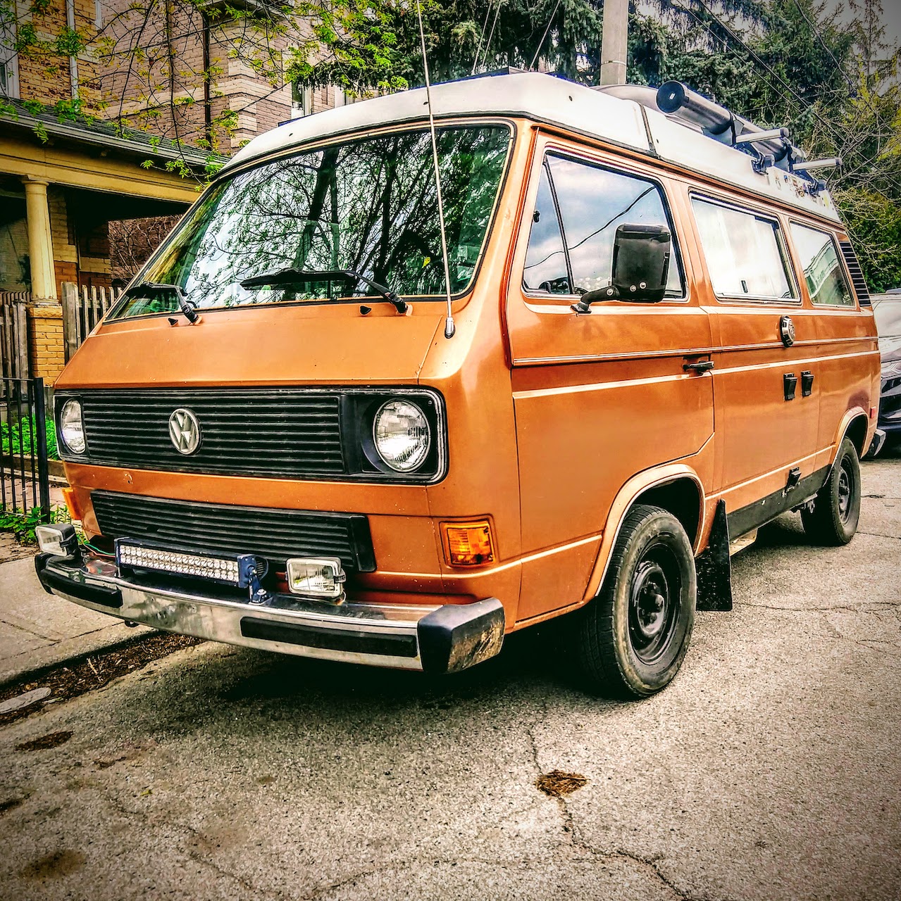 Front right view of a tan Volkswagen Westfalia T3