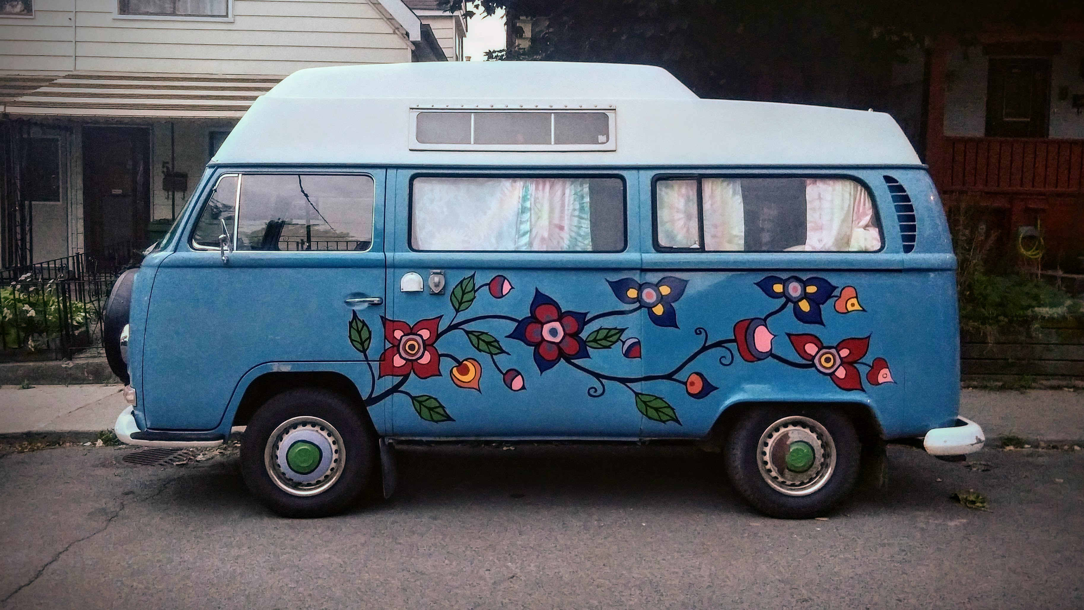 Side view of a retro Volkswagen T2 Camper van with flower decal